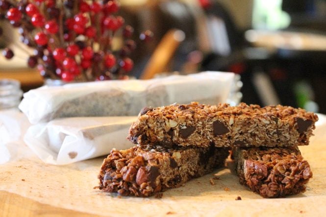 Stack of homemade granola bars on a wooden countertop