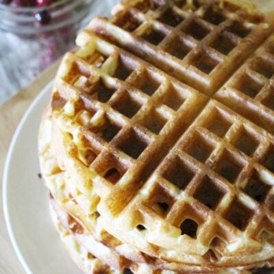 Stack of finished einkorn waffles on a white plate