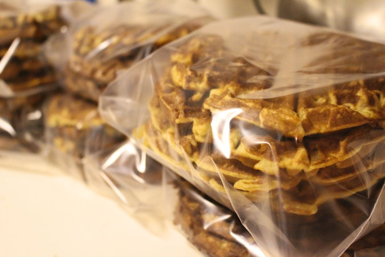 Many ziploc bags filled with einkorn waffles ready to freeze.