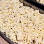 A freeze dryer tray with finished freeze dried mashed potatoes in crumbles