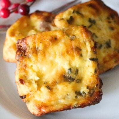 Close up of 3 homemade copycat starbucks potato cheddar and chive bakes on a white plate.