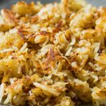 Plate of finished fried homemade hash browns from homemade frozen hash browns.