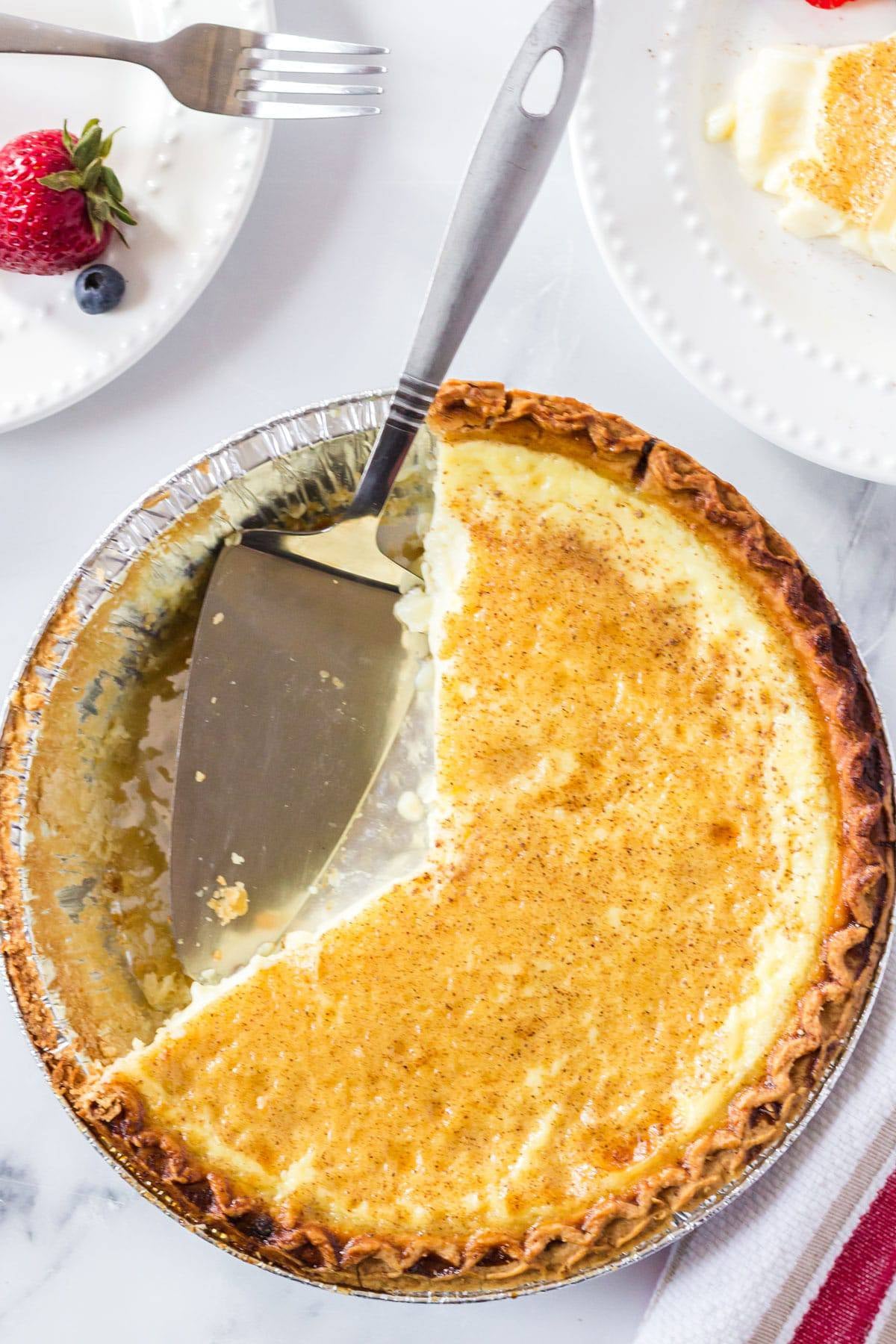 top down view of egg custard pie with a slice missing