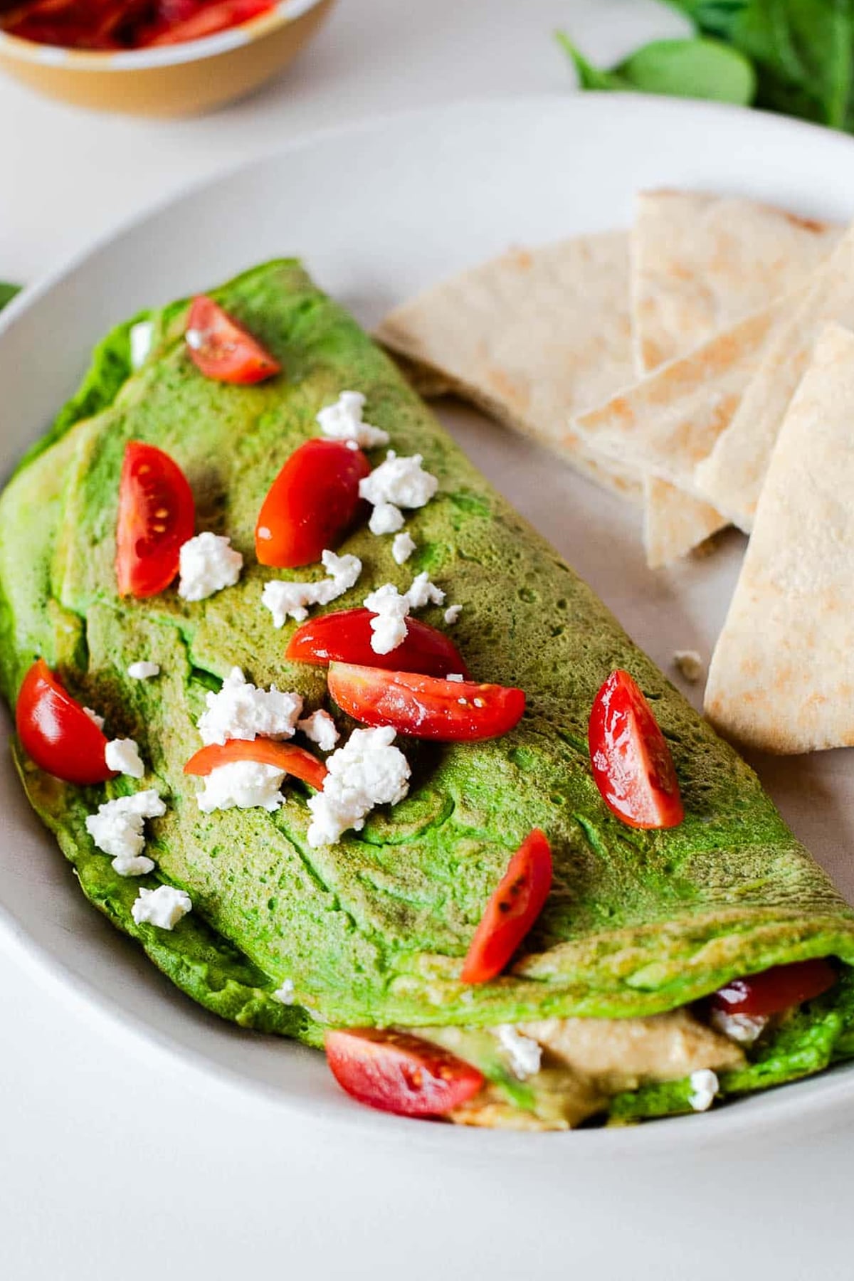 close up of a finished Green Hummus Omelet Recipe with Tomatoes and Feta