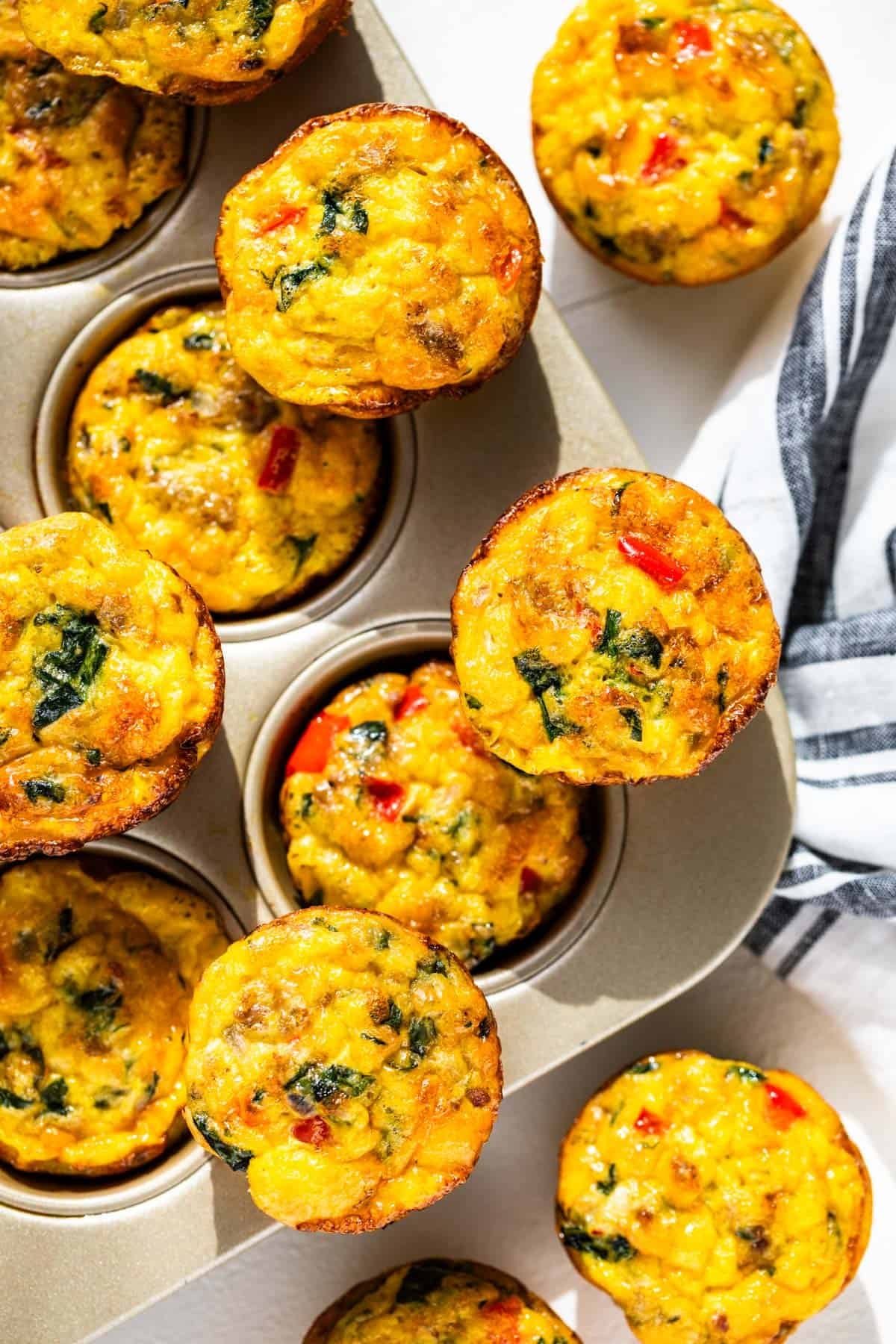 a muffin tin filled with baked Sausage Egg Muffins