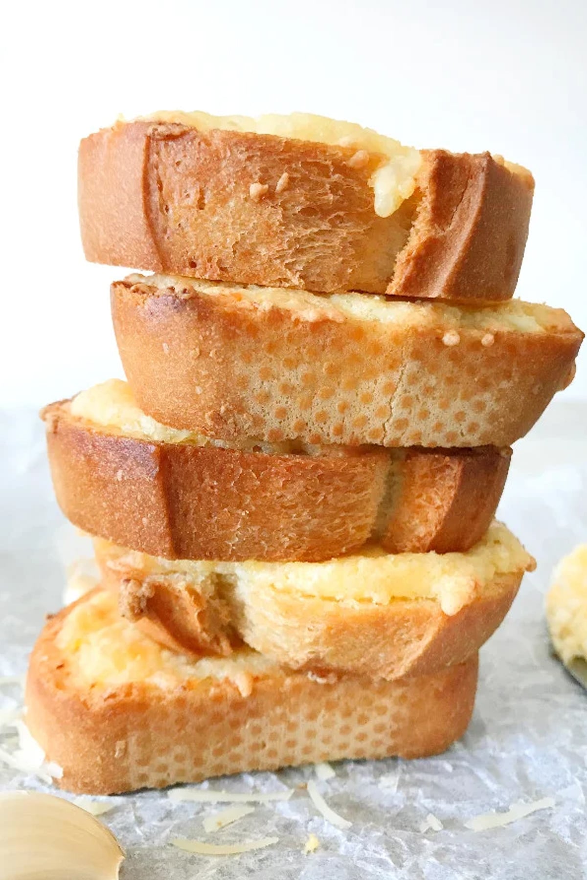 close up of Warm Egg and Cheese Crostini stacked on parchment paper