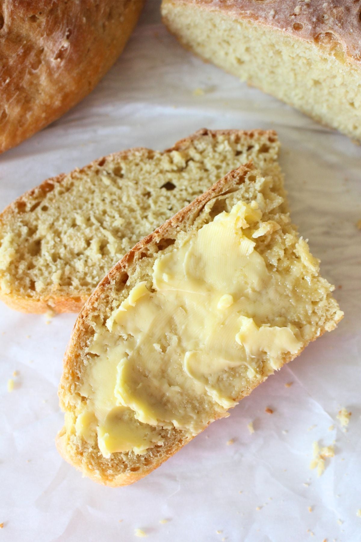 2 slices of homemade einkorn peasant bread with butter