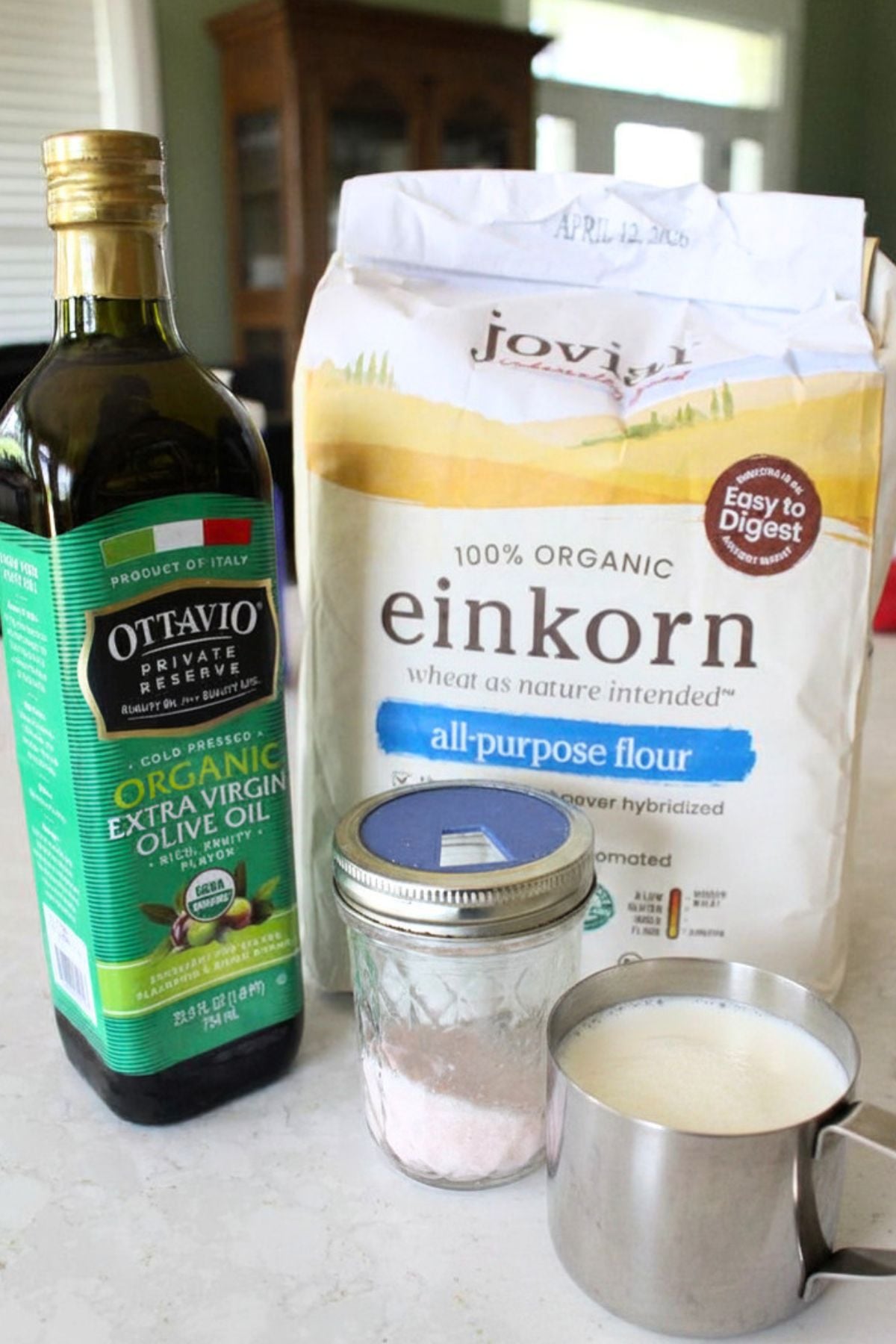 Ingredients for unleavened bread, including flour, salt, milk, and olive oil