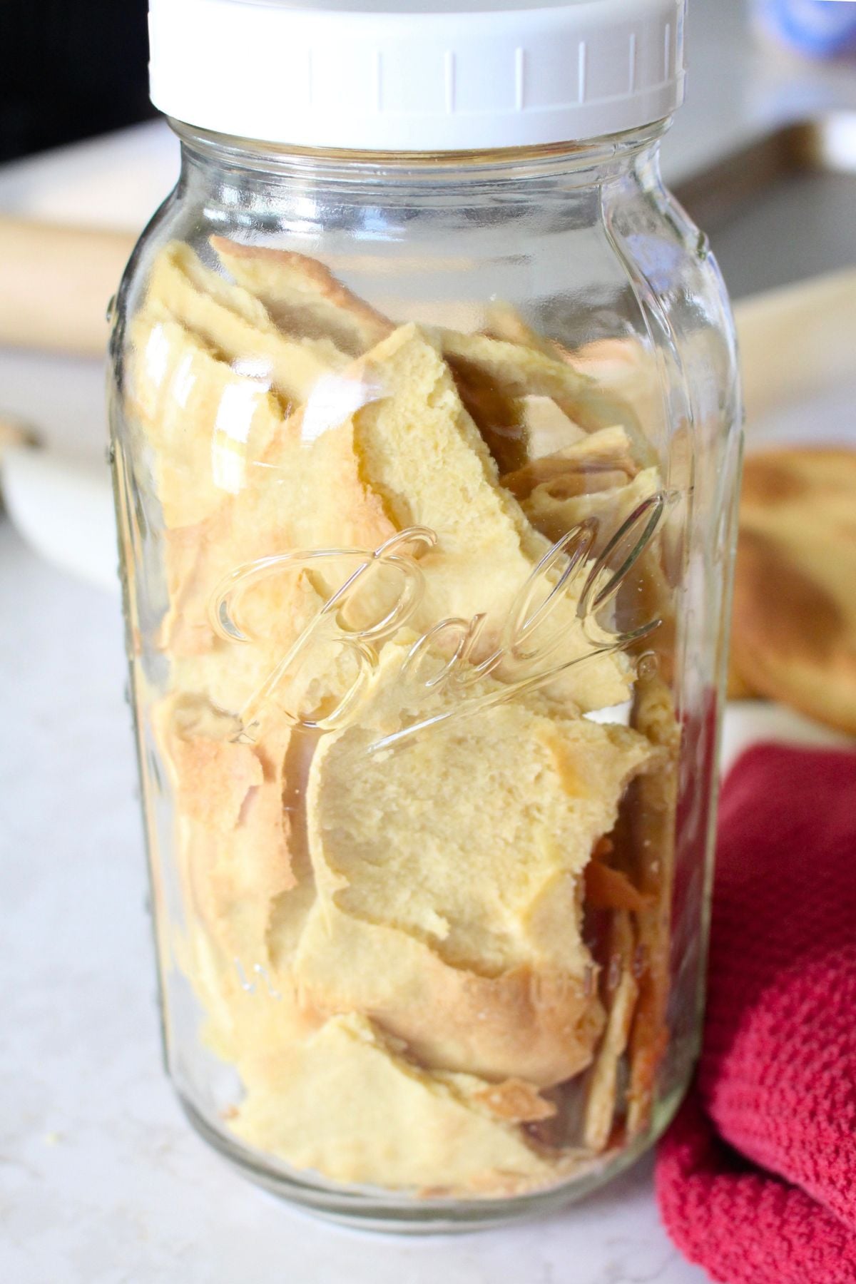 a full half gallon glass jar of pieces of homemade unleavened bread.