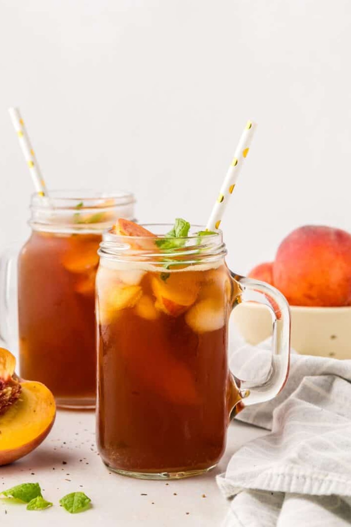 Peach Iced Tea in mason jar glasses with handles and polka dot straws