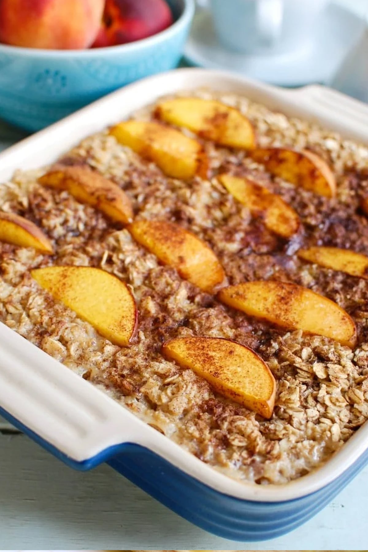 Peaches and Cream Baked Oatmeal in a blue baking dish