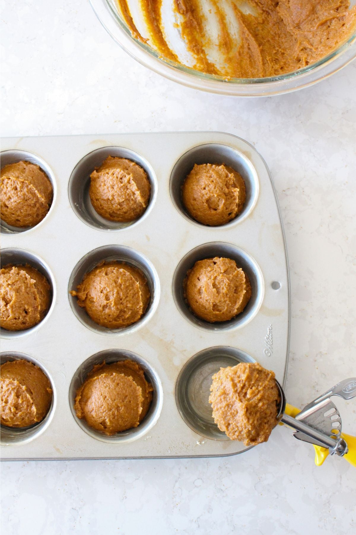 portioning the batter into a muffin tin