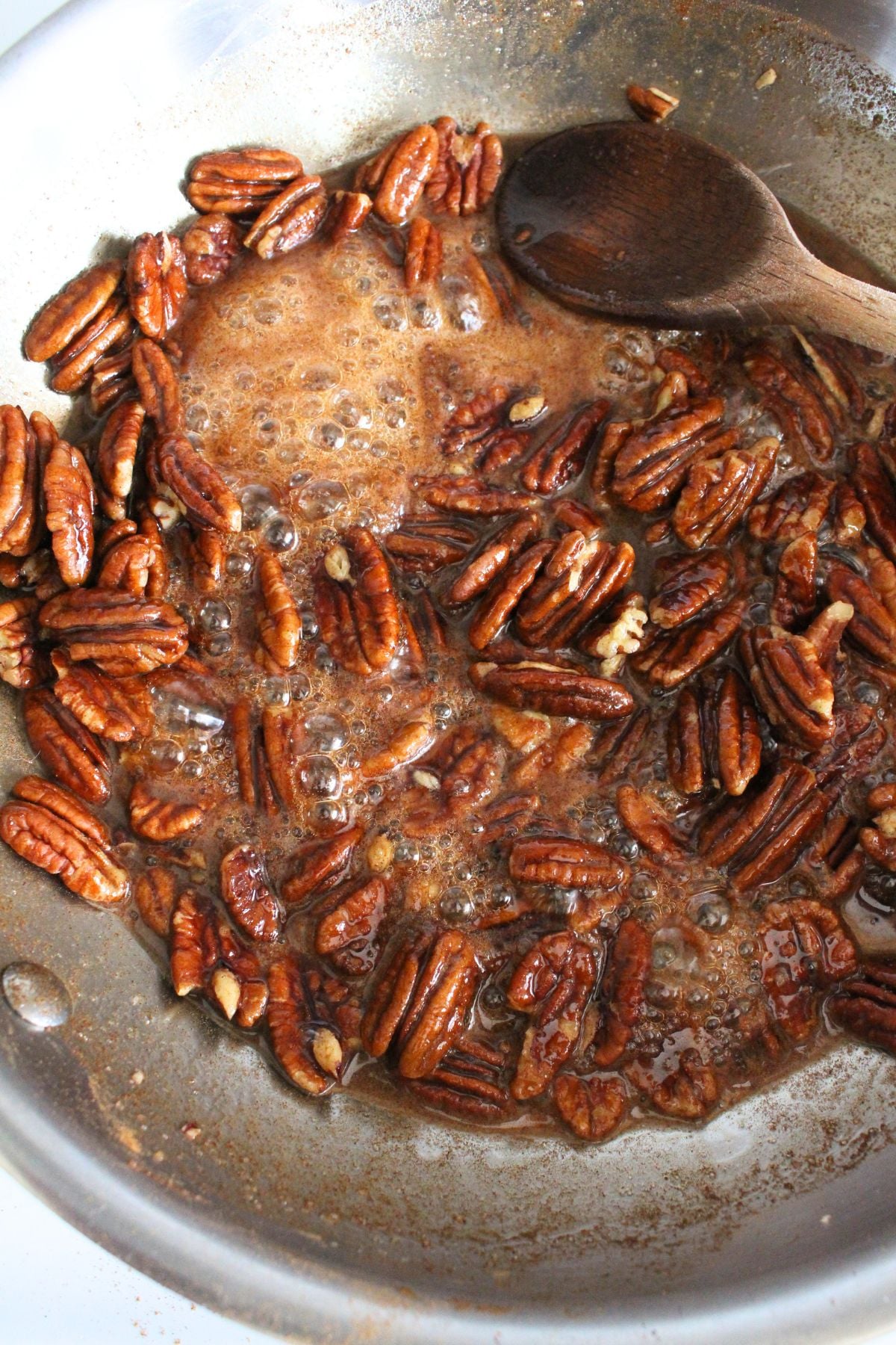 Cinnamon sugar pecans cooking in a skillet