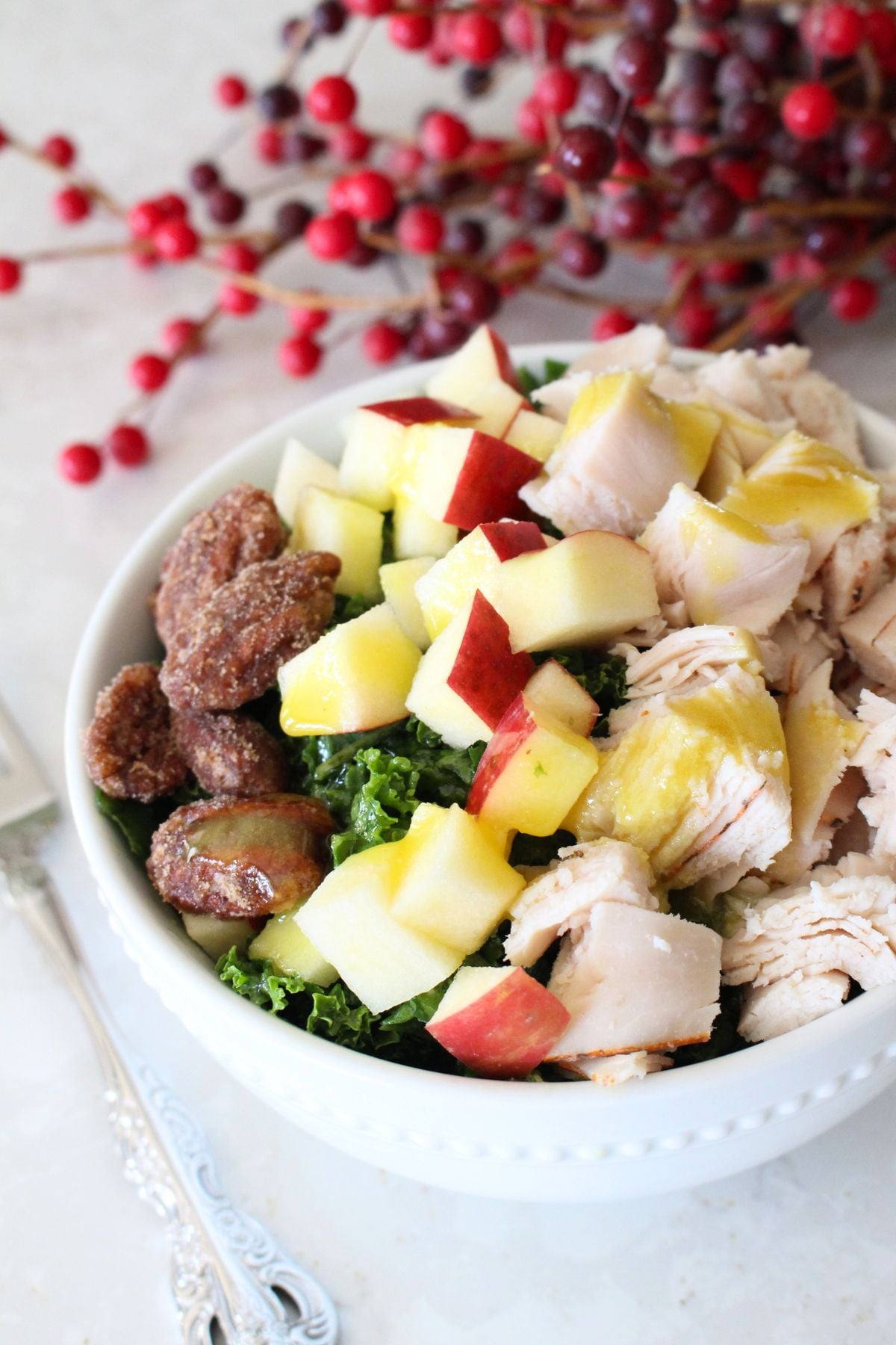 Finished turkey apple pecan kale salad in a white bowl