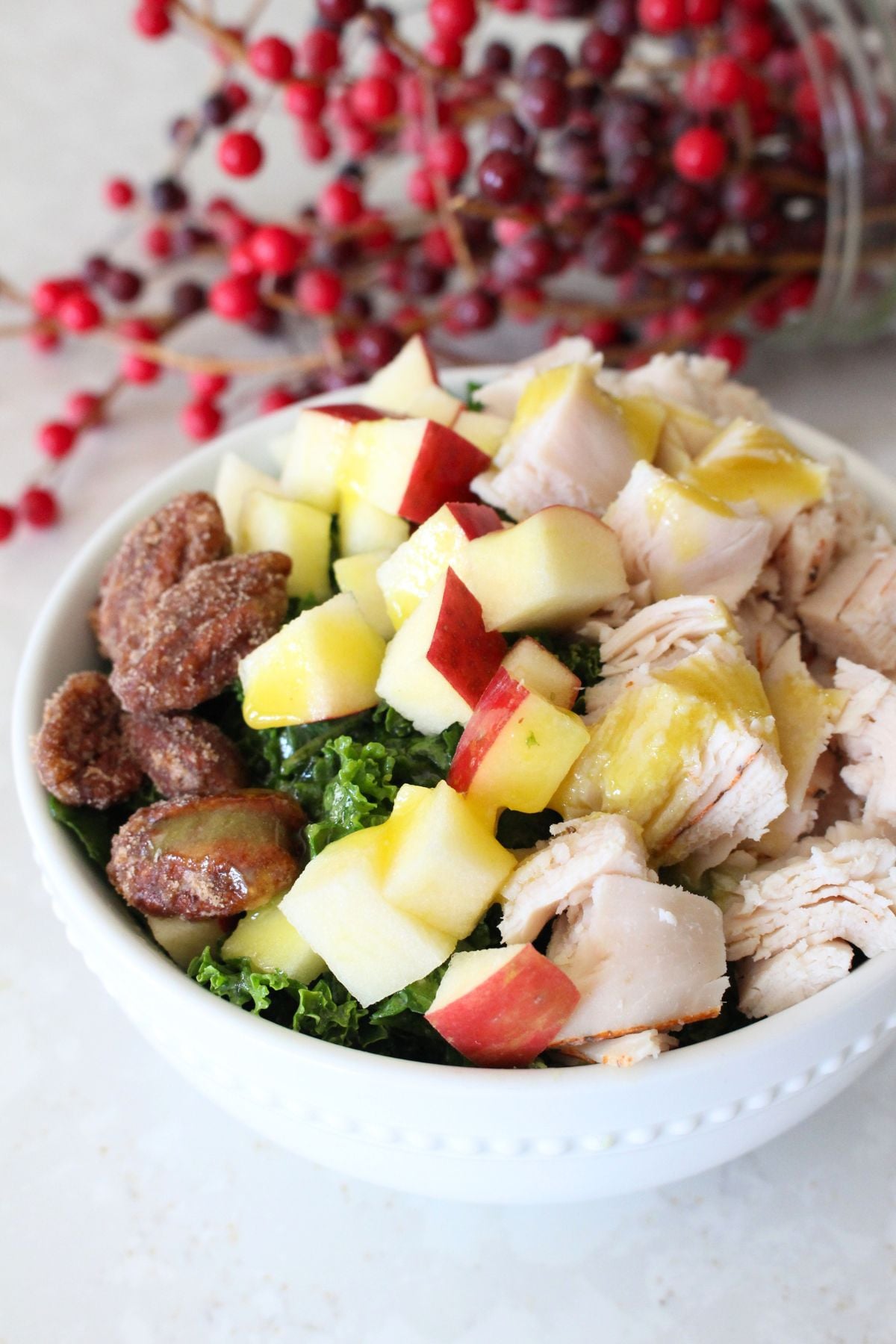 Finished turkey apple pecan kale salad in a white bowl